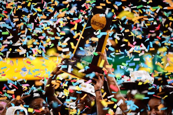 2019 Division I Women's Basketball Champions holding trophy with confetti.