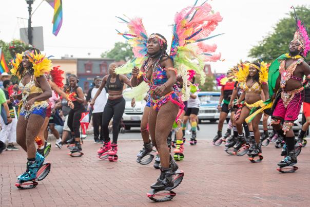 A group of black people in costumes march in the Juneteenth parade in Annapolis, MD.