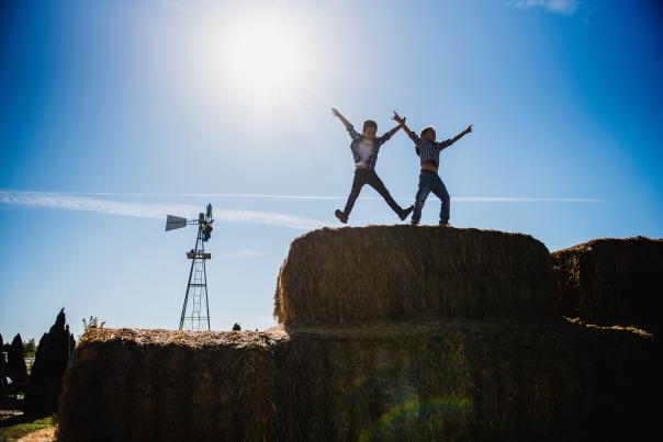 Kids playing on haystack