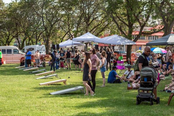 Festivalgoers playing cornhole at the 2024 Taco & Tequila Festival in Lansing
