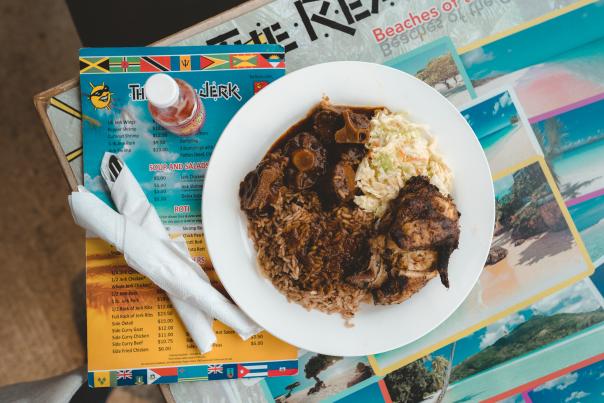 Plated dish atop a menu at The Real Jerk Restaurant in Toronto