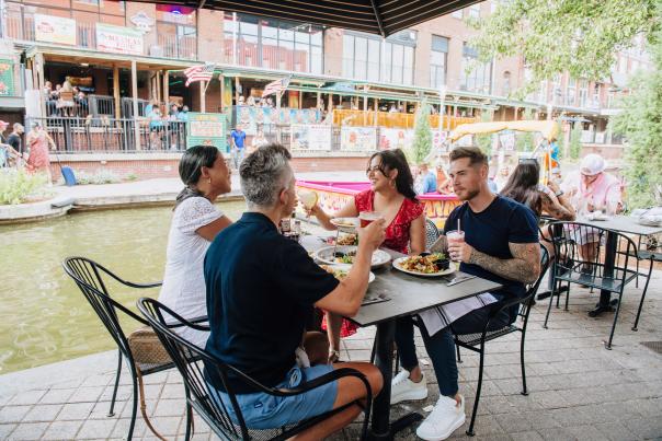 Two couples dining at Bourbon Street Cafe along the Bricktown Canal