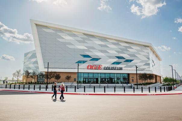 Two people hand-in-hand walking into the new OG&E Coliseum in Oklahoma City.