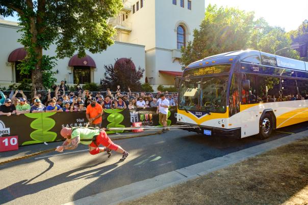 Man pulling a bus at the World's Strongest Man competition