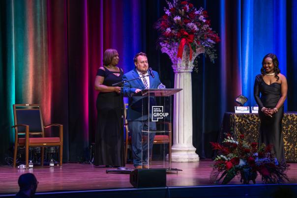A man stands at a podium on a stage