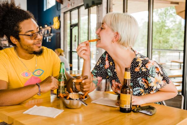 Couple sharing fries at downtown restaurant