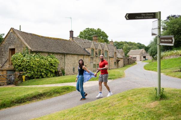 A couple holding hands walking in Notgrove