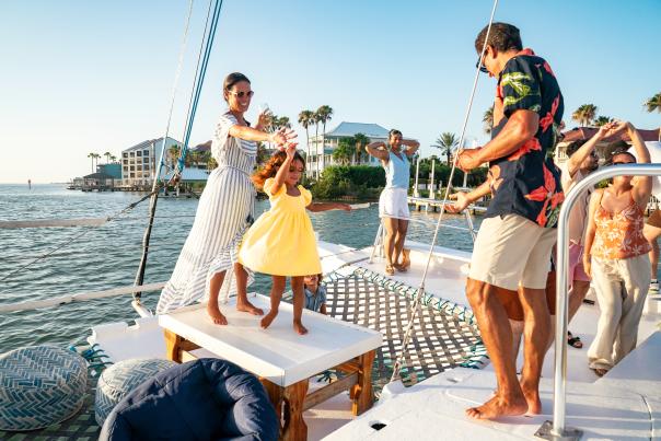Multi-generational family having a great time and dancing on a catamaran cruise.