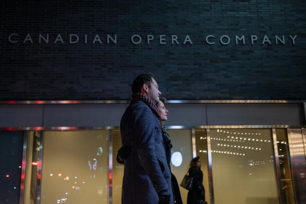 A couple walks outside Canadian Opera Company, Four Seasons Centre for the Performing Arts