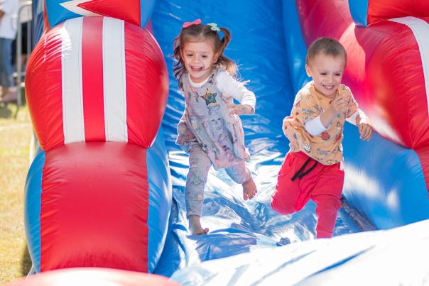Kids playing on inflatable slide at The Cynthia Woods Mitchell Pavilion during The Children's Festival