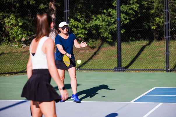 Woman serving in pickleball game