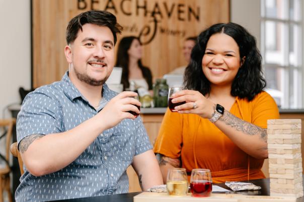 a couple enjoying samples of wine and playing table games
