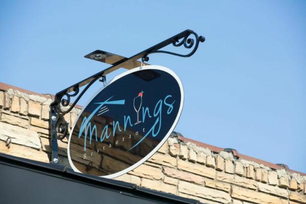 The exterior sign for Manning's Restaurant in Clayton, NC.