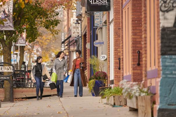 Three women shopping together in the vibrant Old Town Lansing, exploring local boutiques and enjoying the unique shops in this artsy district.