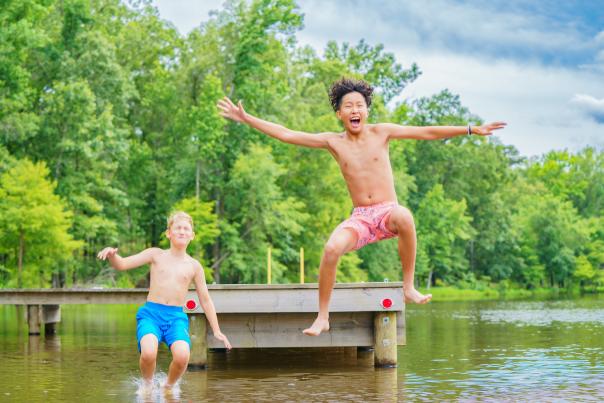 Two Boys Jumping Off a Pier at Cypress Black Bayou