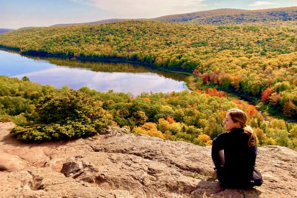 A woman overlooking Lake of the Clouds during fall color in the Upper Peninsula