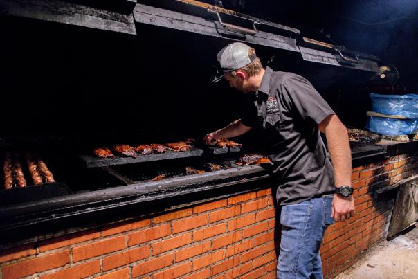 Pitmaster at the grill at Black's BBQ Lockhart. Courtesy of The Original Black's Barbecue.