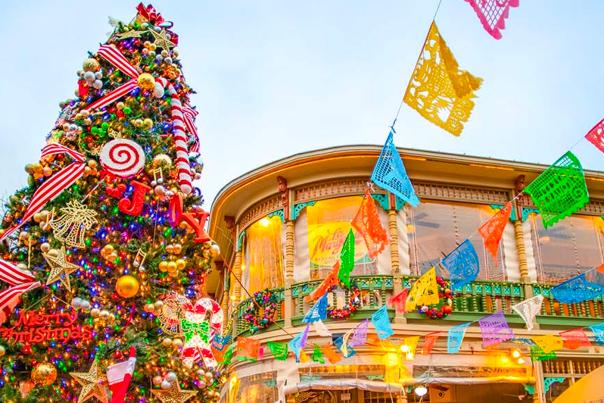 Festive Christmas tree next to papel picado