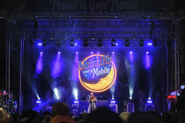 Performer on a purple lit stage with Moonpie logo