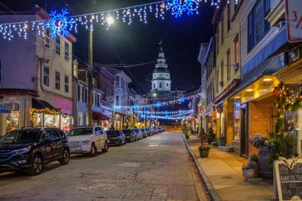 An empty street at night with christmas lights hung up in front of the Maryland State House in