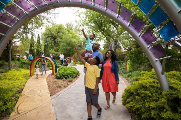 Family walks on a path at the Botanica Gardens in Wichita