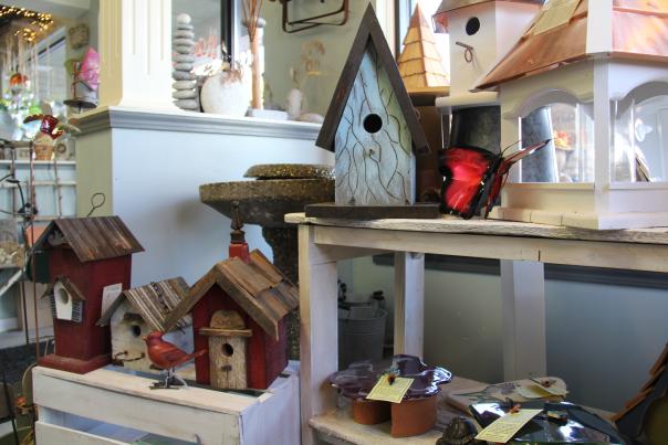 Decorative birdhouses fill the shelves of a local small business.