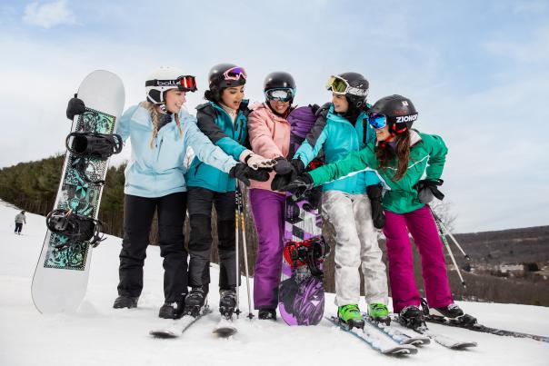 A group of skiers and snowboarders prepare for a day on the slopes at Camelback Mountain in the Poconos.