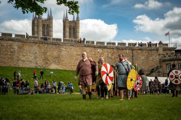 A group of people re-enacting historic battles and life