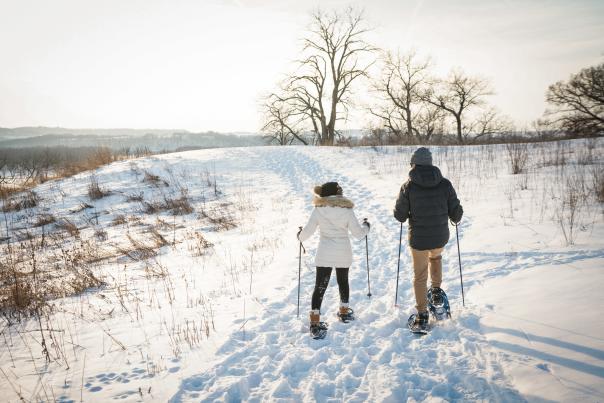 Couple snowshoeing on hillside
