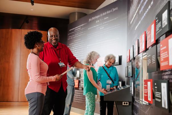 Two people looking at an exhibit at First Americans Museum