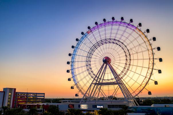An aerial view of The Wheel at ICON Park on International Drive at dusk