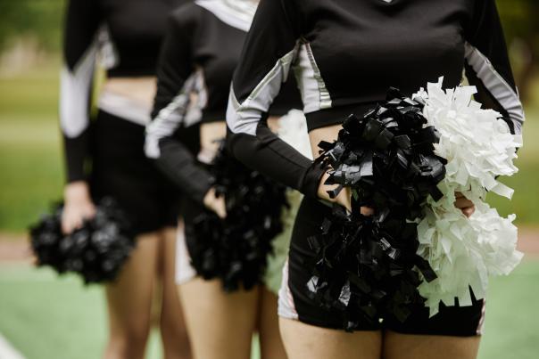 Cheerleading Women Dancing With Pompom