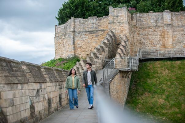 Couple walking along the walls of the Castle looking at the views