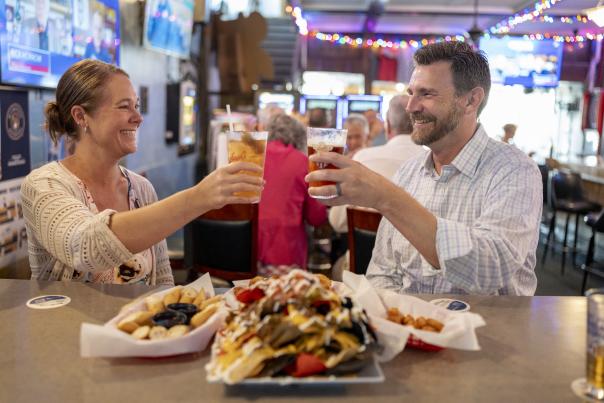Two people at Fat Seagull cheersing