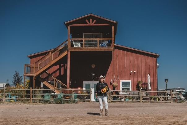 Women in chef coat standing in front of a barn