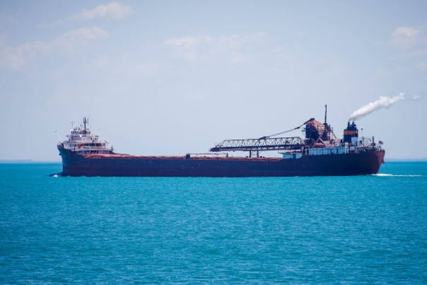 great lakes freighter sails on blue lake