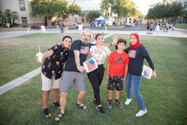 three teen children with parents all wearing patriotic clothing