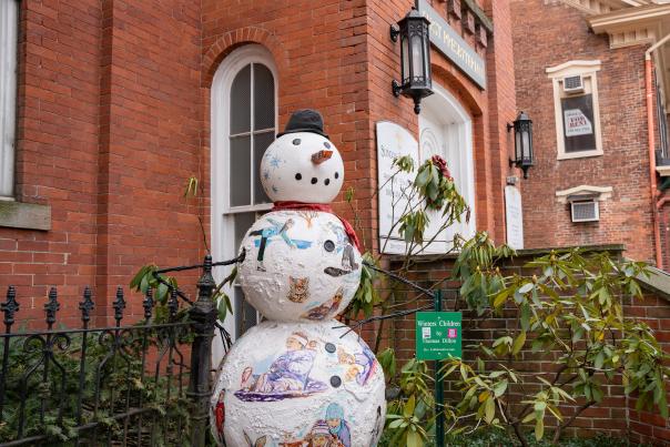 One of the Snowman of Stroudsburg looks out over the winter street.