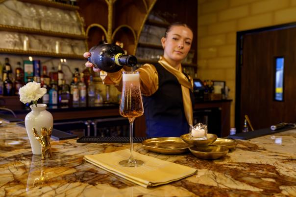 A bartender pours a drink at The Olivet at The Swiftwater.