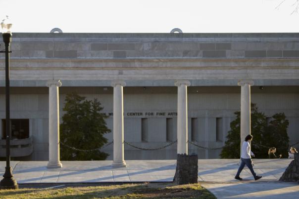 A student walking across the Colonnades structure at Western Kentucky University located in Bowling Green, Ky