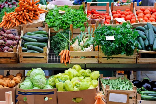 bins of a variety of vegetables at a farmers market