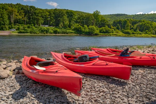 Kayaks wait for paddlers along the Delaware River in the Poconos
