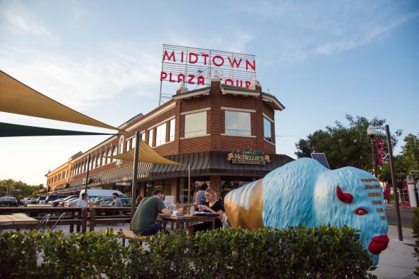 Couple enjoying drinks and dinner on restaurant patio in Midtown, Oklahoma City