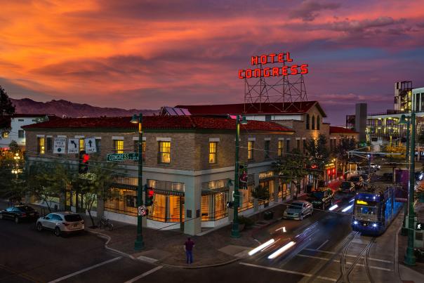 Cityscape of Downtown Tucson with Hotel Congress sign, Sun Link streetcar, and Vibrant Nightlife