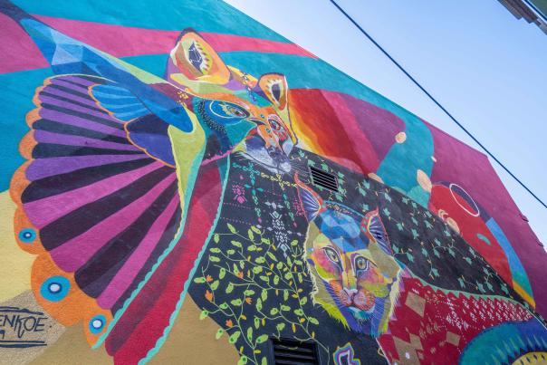 Brightly colored mural of a cat, fox, and bird is part of the Flint Public Art murals in downtown Flint, Michigan.