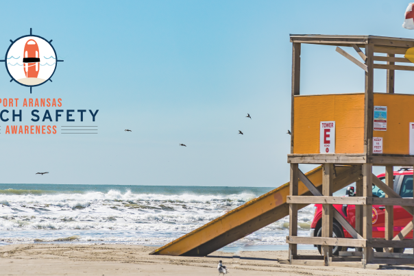 A surf rescue tower sits on the beach in the right hand of the photo. The left side of the beach in the photo has a logo that reads "Port Aransas Beach Safety Awareness."