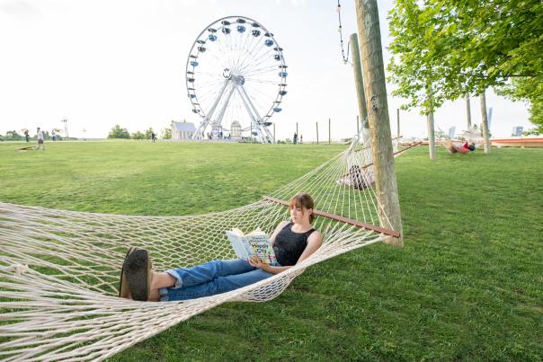 A girl reading a book in a hammock