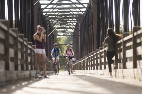 Bikers on the Phoenix Park pedestrian bridge in downtown Eau Claire