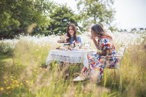 Two women enjoying afternoon in the meadow at Bourton Hill Gardens