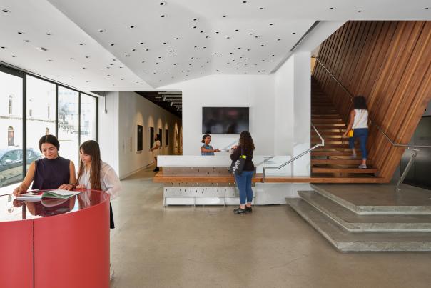 Lobby of the Contemporary Austin - Jones Center with visitors checking in, heading off to exhibits and exploring within the welcome area.